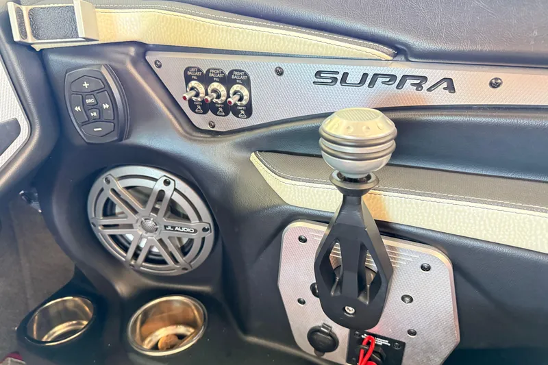 Slide: The Image of 2017 Supra SA450 interior with audio controls, speaker, and gear shift. - 17