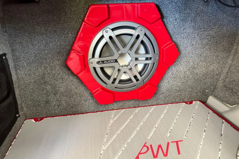 Slide: The Image of Red JL Audio subwoofer in 2017 Supra SA450 boat interior. - 18