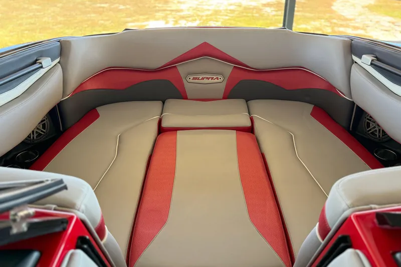 Slide: The Image of 2017 Supra SA450 boat interior with red and gray seating, featuring premium design. - 20