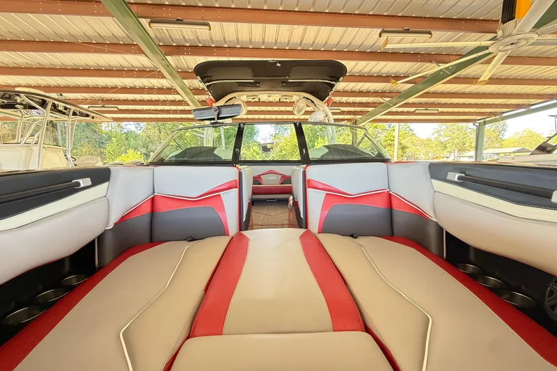 Slide: The Image of 2017 Supra SA450 boat interior with red and gray seating under a metal roof. - 21