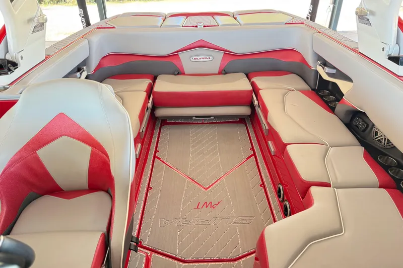 Slide: The Image of 2017 Supra SA450 boat interior with red and gray seating and premium flooring. - 22