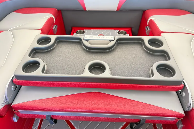 Slide: The Image of 2017 Supra SA450 boat interior with red and gray seating and cup holder tray. - 23