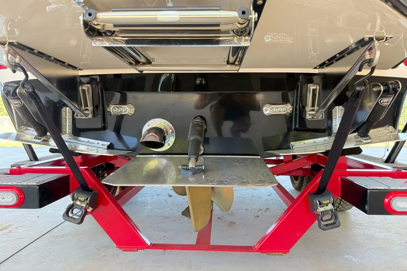 Slide: The Image of Rear view of a 2017 Supra SA450 boat on a red trailer. - 32