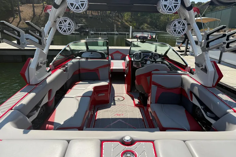 Slide: The Image of 2017 Supra SA450 boat with red accents, parked under a metal roof. - 6