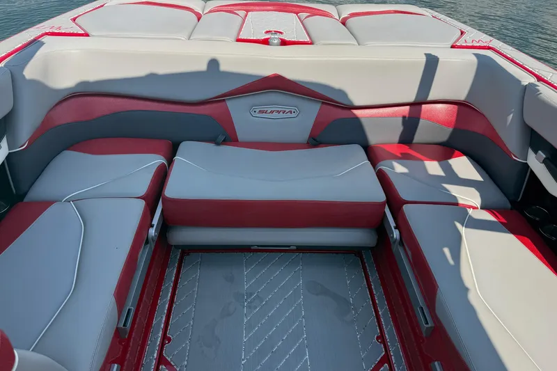 Slide: The Image of 2017 Supra SA450 boat with red trailer, parked under a metal roof. - 8