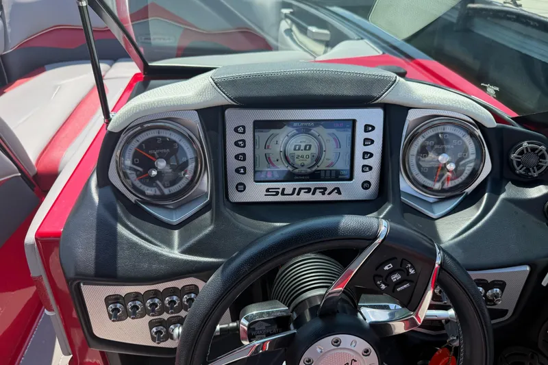 Slide: The Image of Interior of a 2017 Supra SA450 boat with red and gray seating. - 9