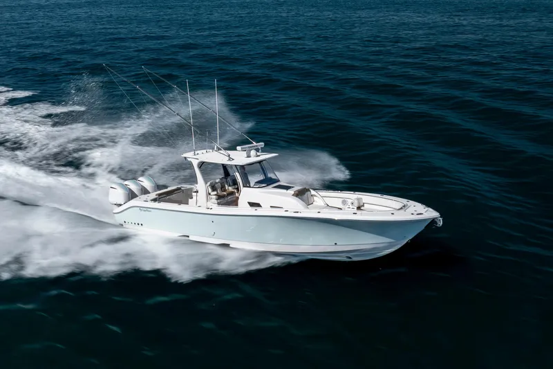 Slide: The Image of 2021 Edgewater 370CC boat cruising swiftly on open ocean waters. - 16
