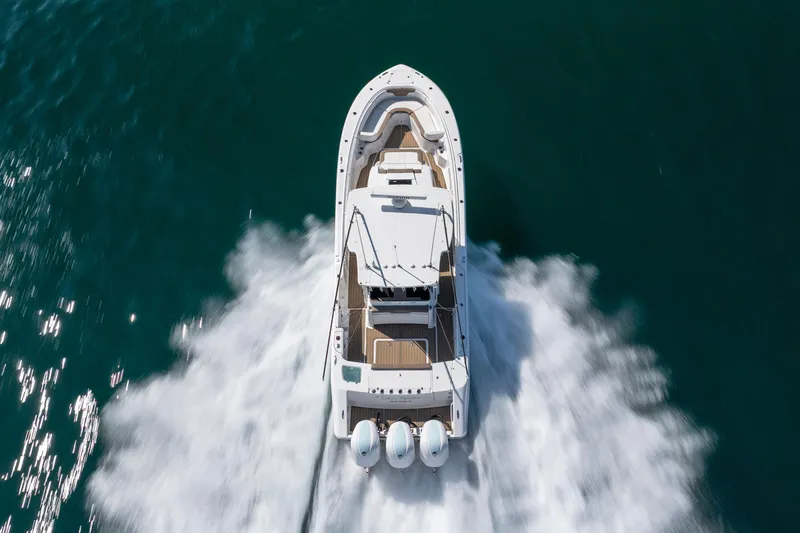 Slide: The Image of 2021 Edgewater 370CC boat cruising on open water, aerial view. - 30