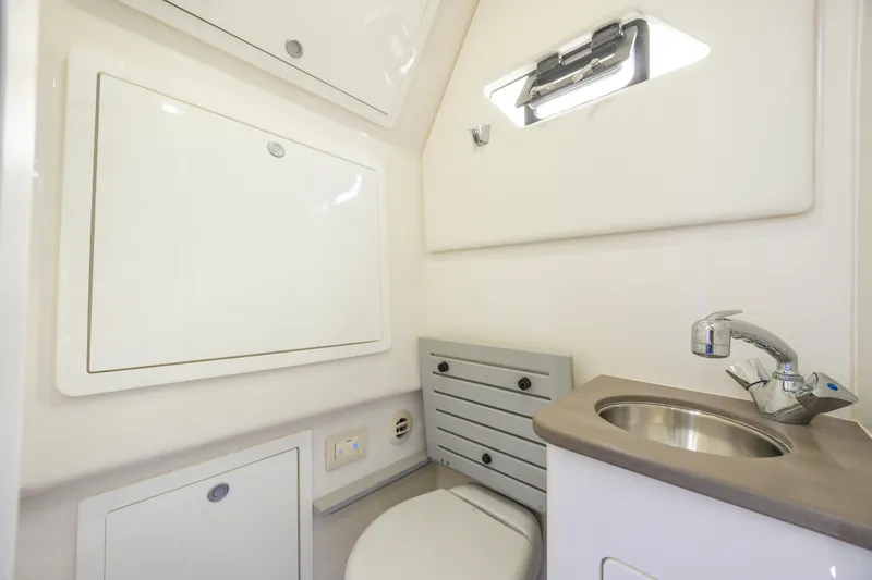 Slide: The Image of 2021 Edgewater 370CC boat interior bathroom with sink and toilet. - 46
