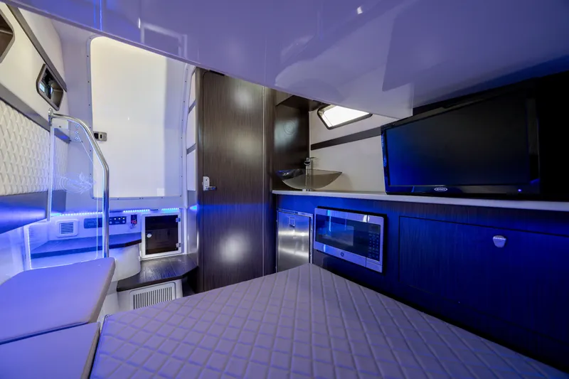 Slide: The Image of Luxurious interior of 2021 Edgewater 370CC boat with modern amenities and blue ambient lighting. - 50