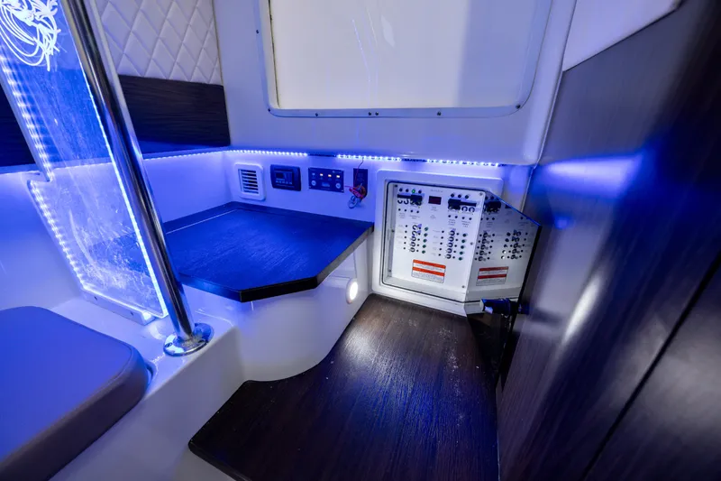 Slide: The Image of 2021 Edgewater 370CC cabin interior with control panels and blue LED lighting. - 52