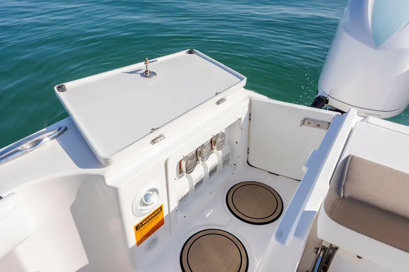 Slide: The Image of 2021 Edgewater 370CC boat deck with storage compartment and engine view. - 58