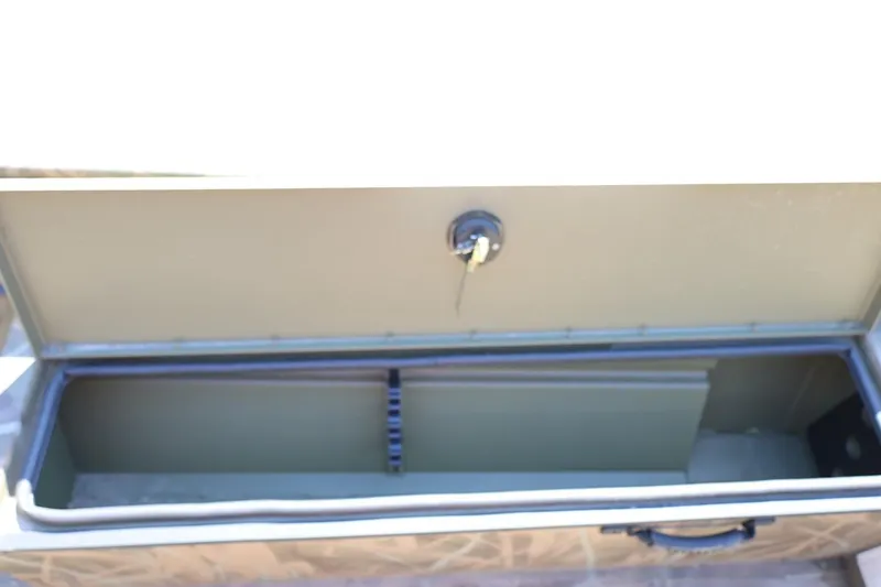 Slide: The Image of Open storage compartment of 2026 Lowe Roughneck RX2070 SC boat, showing interior space. - 12