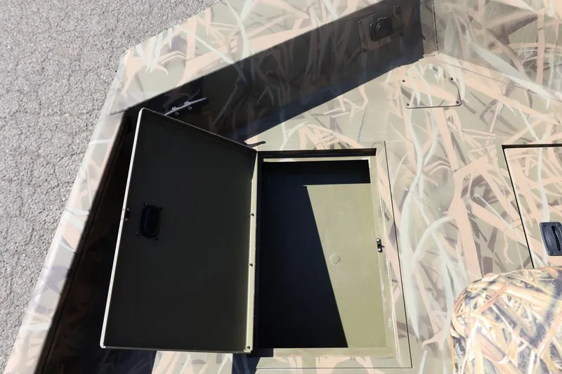 Slide: The Image of 2026 Lowe Roughneck RX2070 SC boat with open storage compartment, camo design. - 14