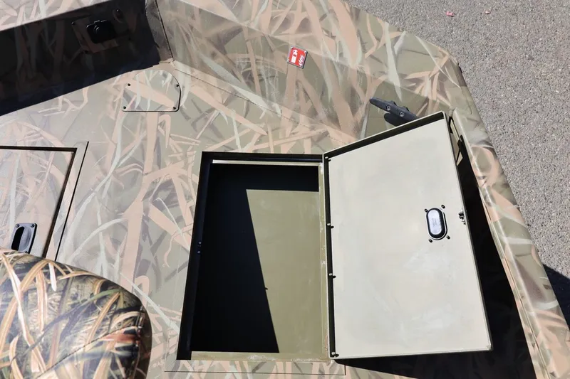 Slide: The Image of Open storage compartment on 2026 Lowe Roughneck RX2070 SC boat with camouflage design. - 16