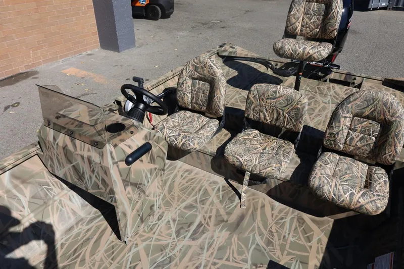 Slide: The Image of 2026 Lowe Roughneck RX2070 SC boat with camouflage seats and steering console. - 18