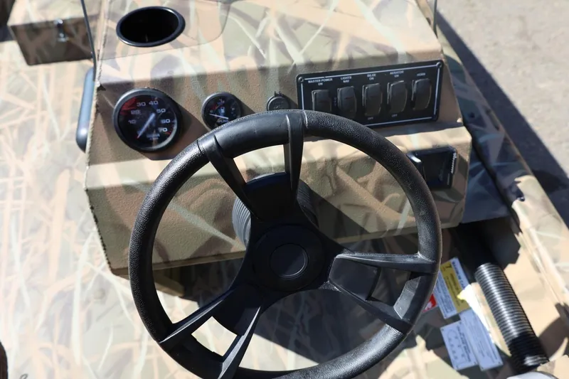 Slide: The Image of Steering console of 2026 Lowe Roughneck RX2070 SC boat with camouflage design. - 21
