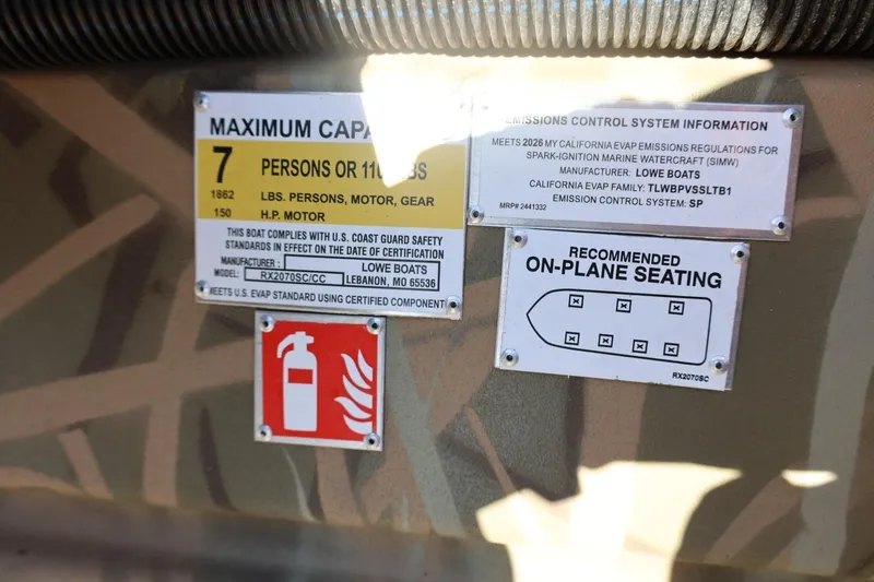 Slide: The Image of Lowe Roughneck RX2070 SC 2026 boat capacity and emissions labels with seating diagram. - 23