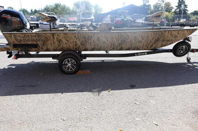 Slide: The Image of 2026 Lowe Roughneck RX2070 SC boat with camouflage design on a trailer. - 5