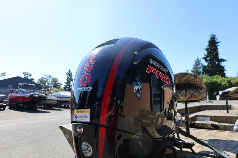 Slide: The Image of 2026 Lowe Roughneck RX2070 SC with Mercury Pro 150 engine in outdoor setting. - 7