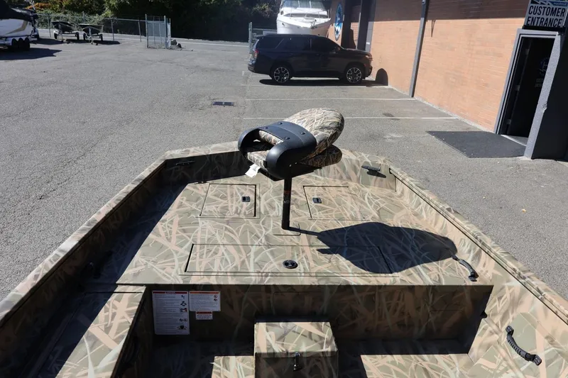 Slide: The Image of 2026 Lowe Roughneck RX2070 SC boat with camo design in parking lot. - 9