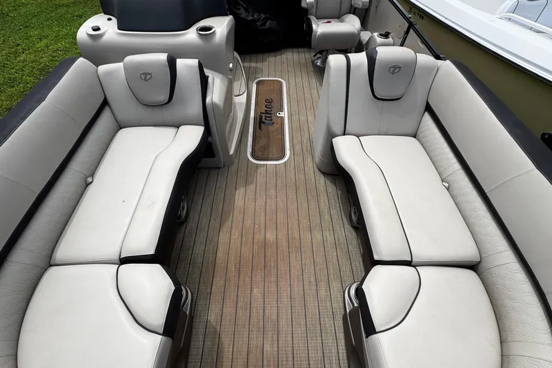 Slide: The Image of 2023 Tahoe Pontoon Cascade Platinum Quad Lounger interior with luxurious seating and wood-style flooring. - 14