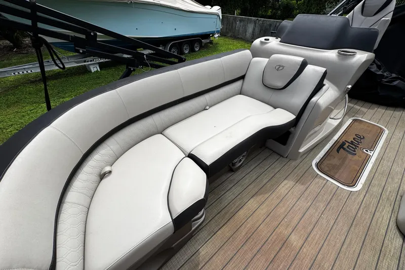 Slide: The Image of 2023 Tahoe Pontoon Cascade Platinum Quad Lounger interior with luxurious seating and wood-style flooring. - 15
