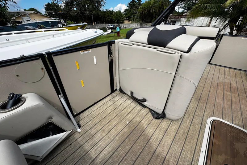 Slide: The Image of 2023 Tahoe Pontoon Cascade Platinum Quad Lounger interior with beige seating and wood flooring. - 18