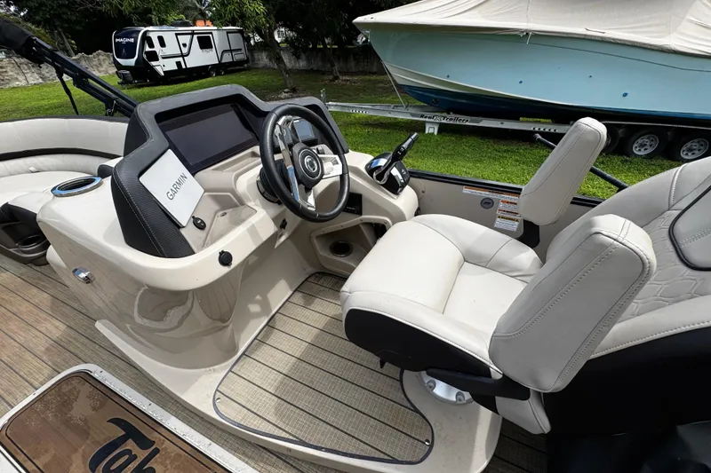 Slide: The Image of 2023 Tahoe Pontoon Cascade Platinum Quad Lounger interior with Garmin navigation system. - 19