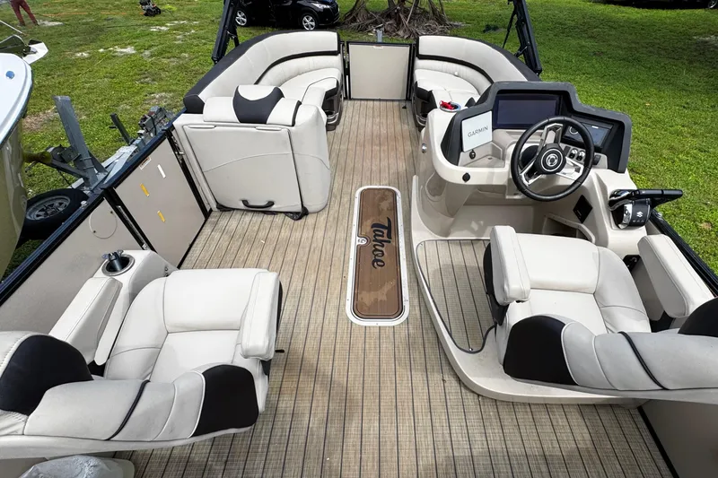 Slide: The Image of 2023 Tahoe Pontoon Cascade Platinum Quad Lounger interior with luxurious seating and modern dashboard. - 23