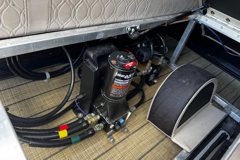 Slide: The Image of 2023 Tahoe Pontoon Cascade Platinum Quad Lounger interior showing hydraulic system components. - 25