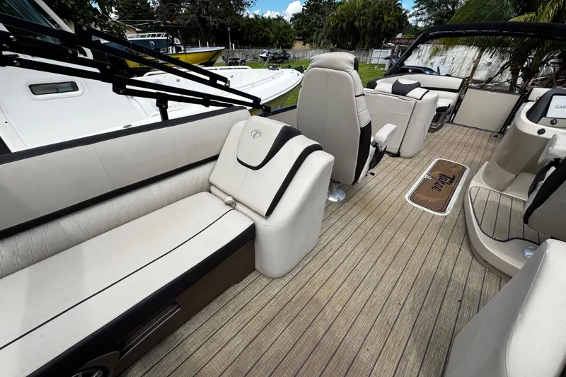 Slide: The Image of 2023 Tahoe Pontoon Cascade Platinum Quad Lounger interior with luxurious seating and wood-style flooring. - 27