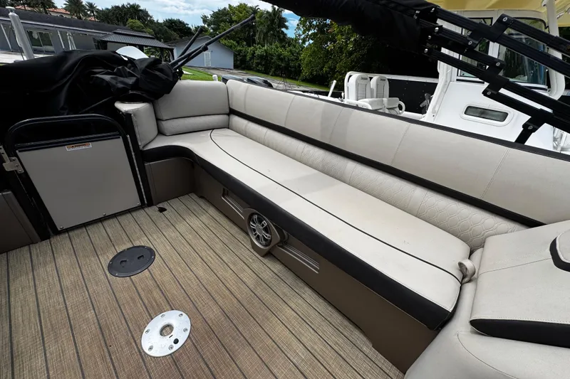 Slide: The Image of 2023 Tahoe Pontoon Cascade Platinum Quad Lounger interior with beige seating and wood flooring. - 30