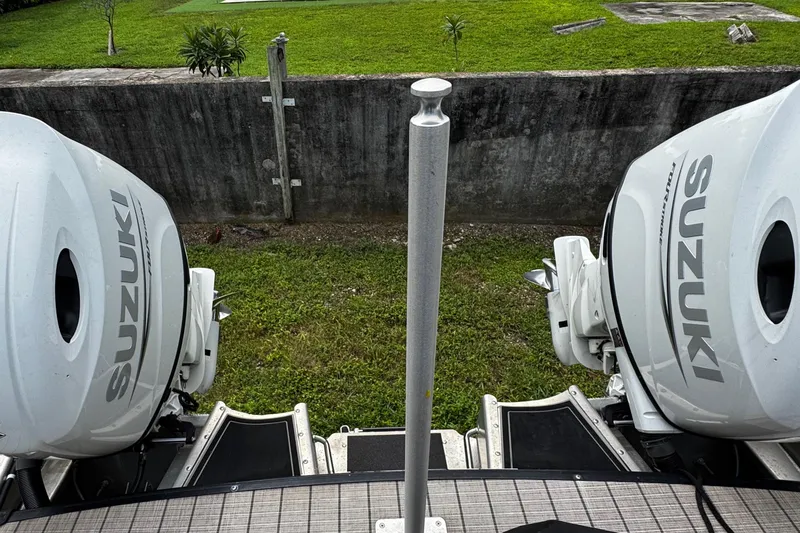 Slide: The Image of 2023 Tahoe Pontoon Cascade Platinum with dual Suzuki outboard motors, rear view. - 35