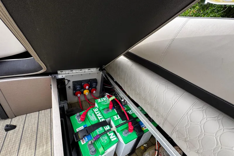 Slide: The Image of 2023 Tahoe Pontoon Cascade Platinum Quad Lounger battery compartment with wiring and seating. - 36