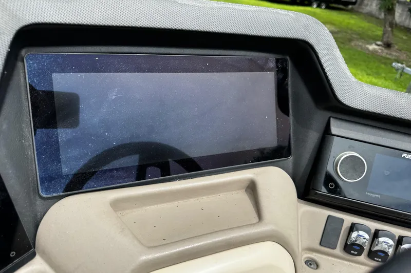 Slide: The Image of Dashboard of 2023 Tahoe Pontoon Cascade Platinum Quad Lounger with touchscreen and controls. - 38