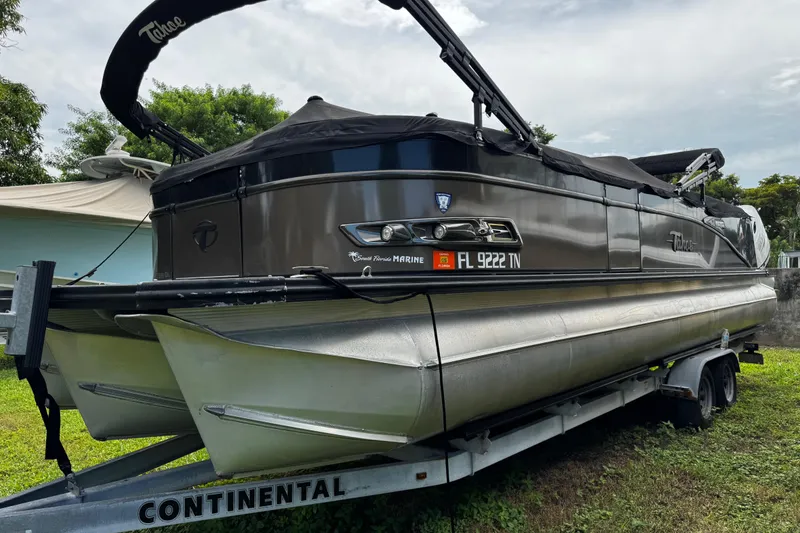 Slide: The Image of 2023 Tahoe Pontoon Cascade Platinum Quad Lounger on trailer, parked outdoors. - 5