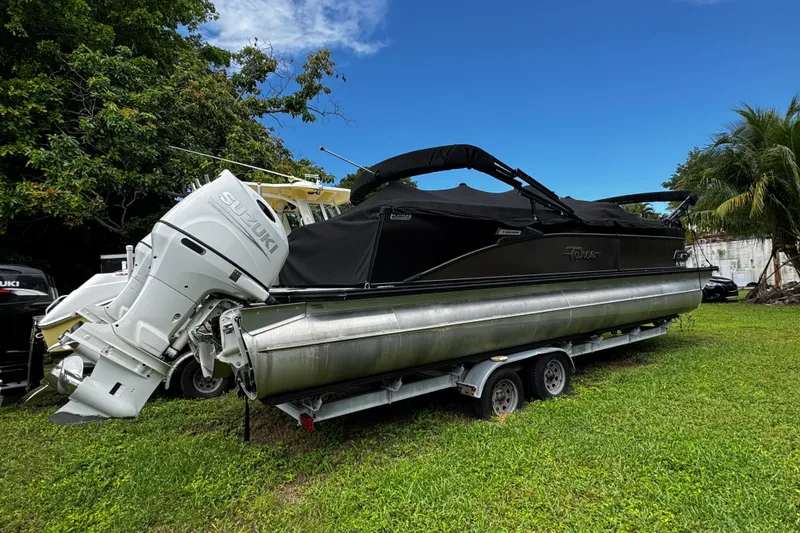 Slide: The Image of 2023 Tahoe Pontoon Cascade Platinum Quad Lounger on trailer, featuring Suzuki outboard motor. - 7