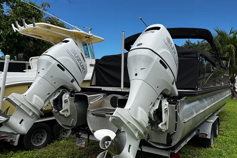 Slide: The Image of 2023 Tahoe Pontoon Cascade Platinum Quad Lounger with dual Suzuki outboard motors on trailer. - 9