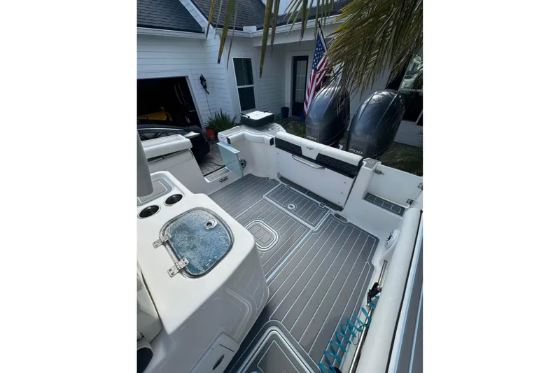Slide: The Image of 2022 Tidewater 272 CC Adventure boat interior with dual engines and sleek deck design. - 13