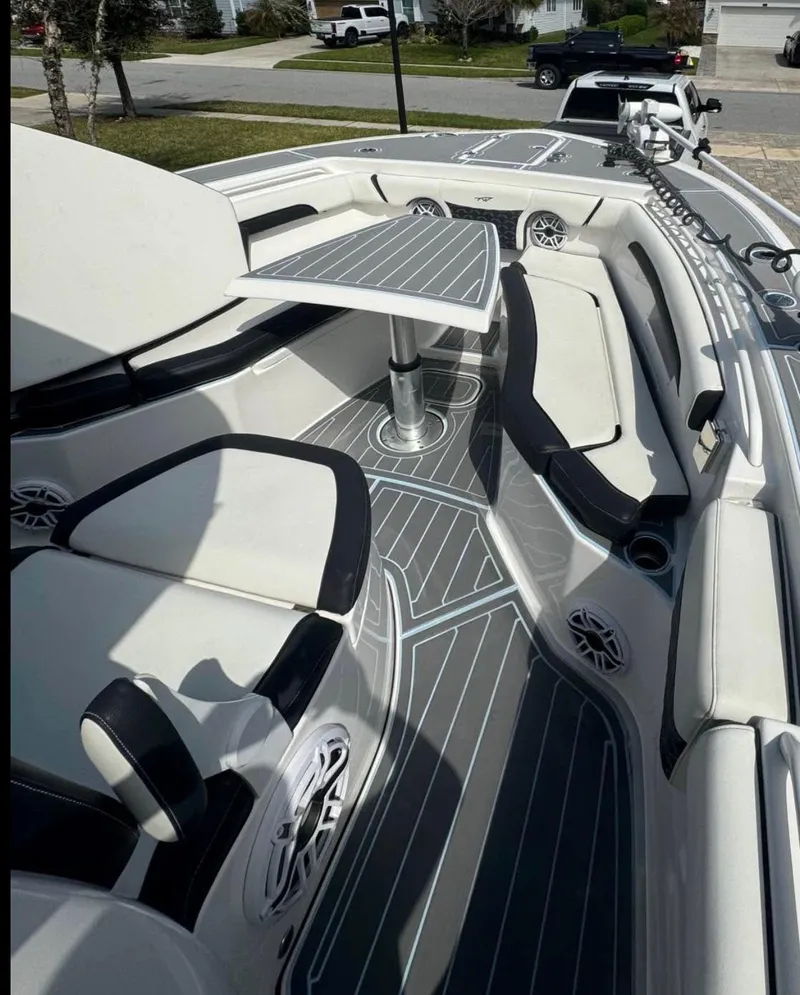Slide: The Image of 2022 Tidewater 272 CC Adventure boat interior with seating and table, featuring sleek design and modern amenities. - 8