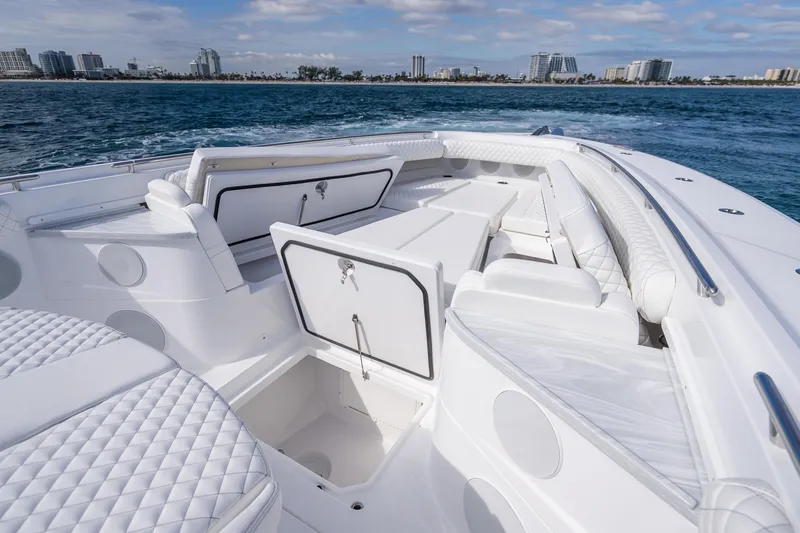 Slide: The Image of 2026 HCB 53 Suenos RXV luxury boat interior with white seating and ocean view. - 10