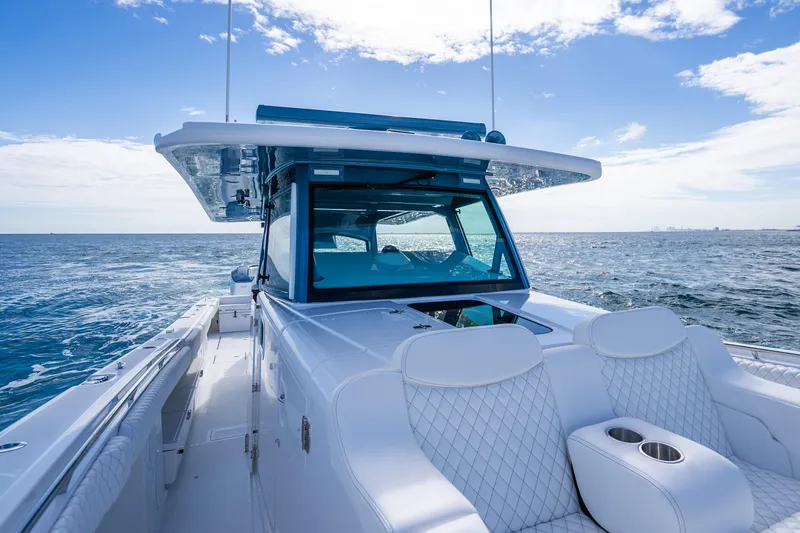 Slide: The Image of 2026 HCB 53 Suenos RXV luxury boat cruising on open sea under clear blue sky. - 14