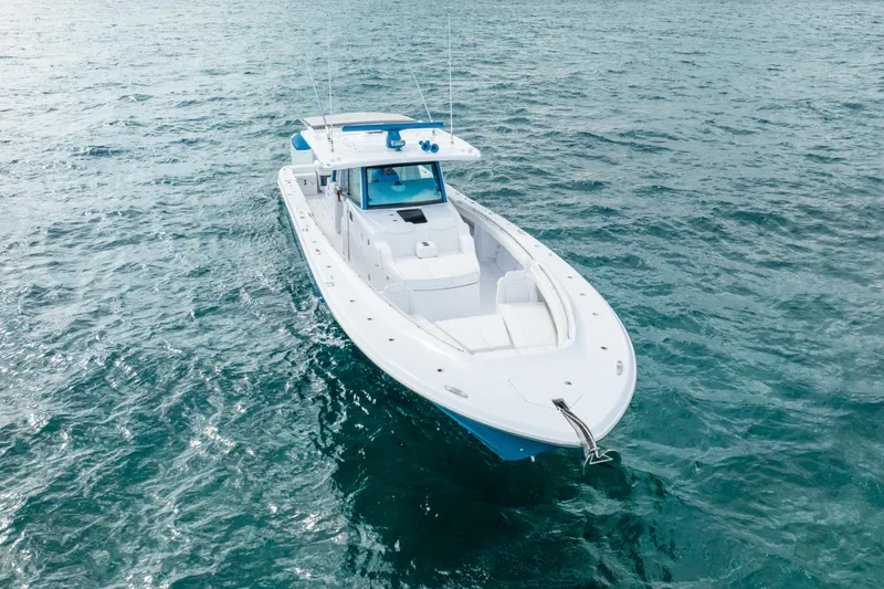 Slide: The Image of 2026 HCB 53 Suenos RXV boat on open water, showcasing sleek design and luxury features. - 2