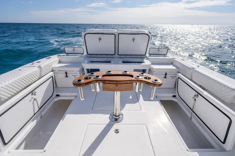Slide: The Image of Luxurious 2026 HCB 53 Suenos RXV boat interior with ocean view and fishing rod holders. - 25