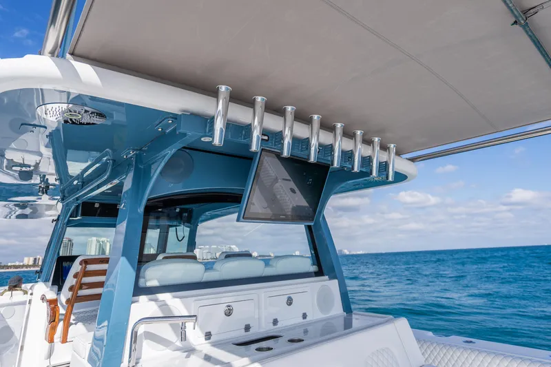 Slide: The Image of Luxury HCB 53 Suenos RXV boat interior with rod holders and ocean view, 2026 model. - 33