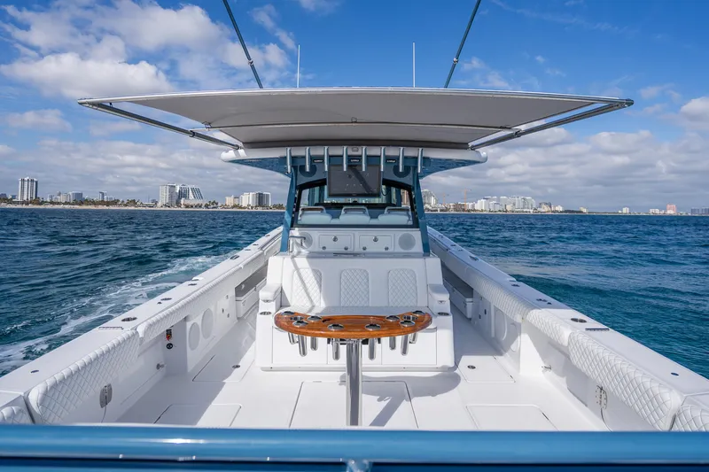 Slide: The Image of 2026 HCB 53 Suenos RXV boat on open water, city skyline in background. - 34