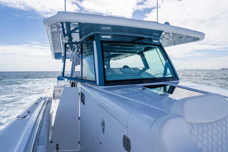 Slide: The Image of 2026 HCB 53 Suenos RXV luxury boat cruising on open water. - 4