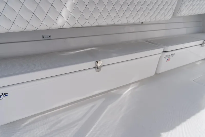 Slide: The Image of 2026 HCB 53 Suenos RXV boat interior with quilted seating and storage compartments. - 40