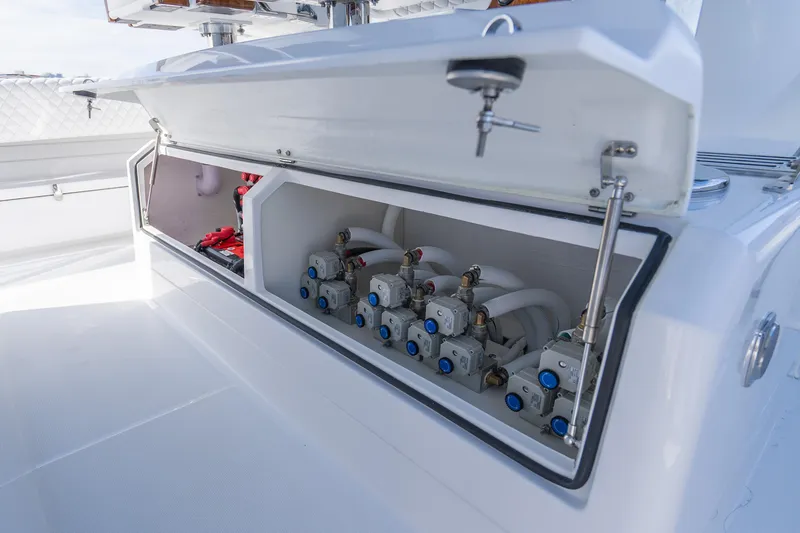 Slide: The Image of Open storage compartment on 2026 HCB 53 Suenos RXV boat, showcasing internal components. - 41